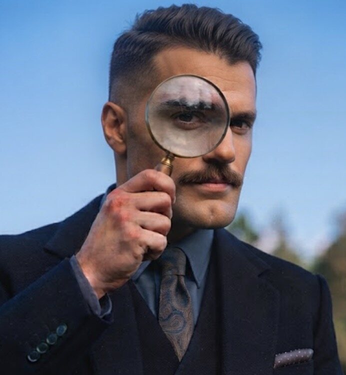 Portrait of M. R. Reese holding a magnifying glass